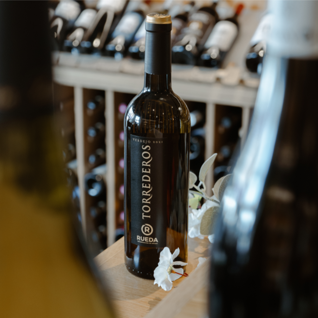 Bottle of Monteregio di Massa Marittima 2020 from Conte San Bonifacio with a glass of red wine, displayed elegantly in a wine cellar setting, highlighting this Italian red wine's craftsmanship