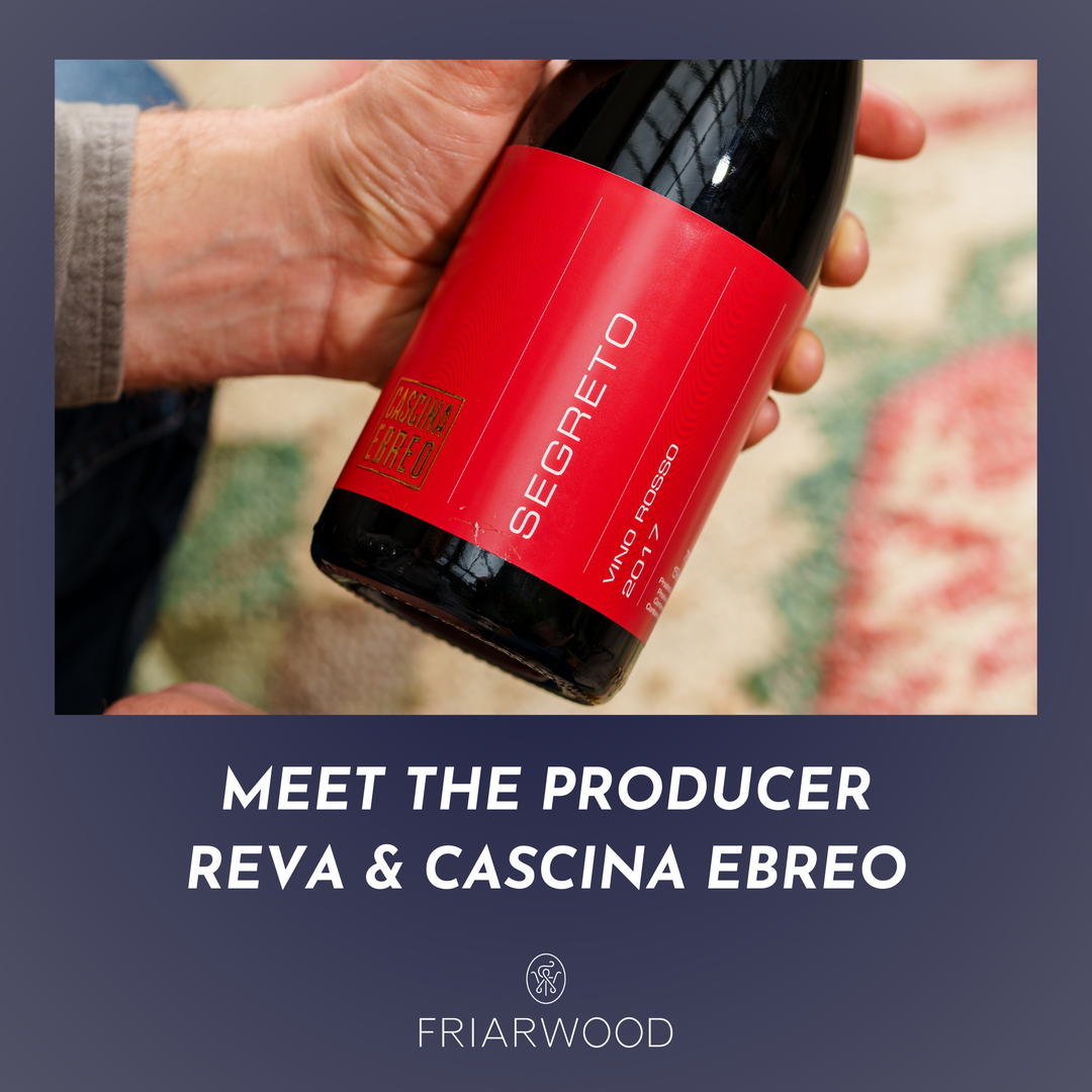 Person holding a bottle of Segreto wine with text about the producer and Friarwood branding.