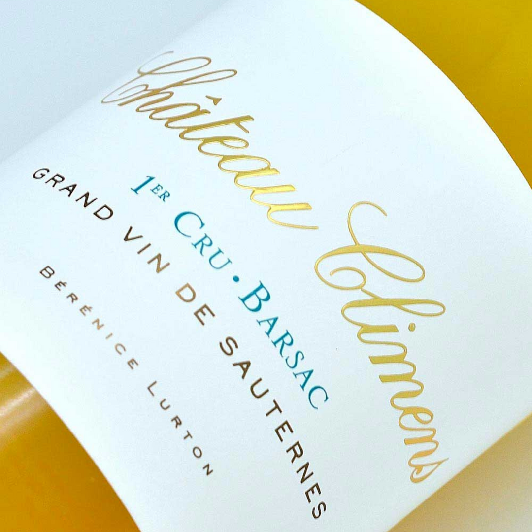 Close-up of Château Climens wine label, showcasing its elegant gold and blue typography.