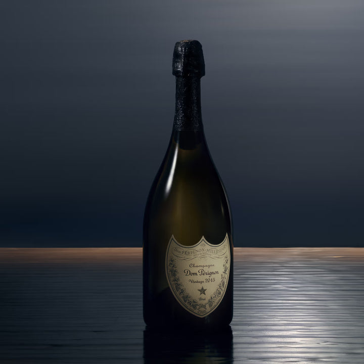 A bottle of Dom Perignon 2015 Vintage in a dark and moody setting