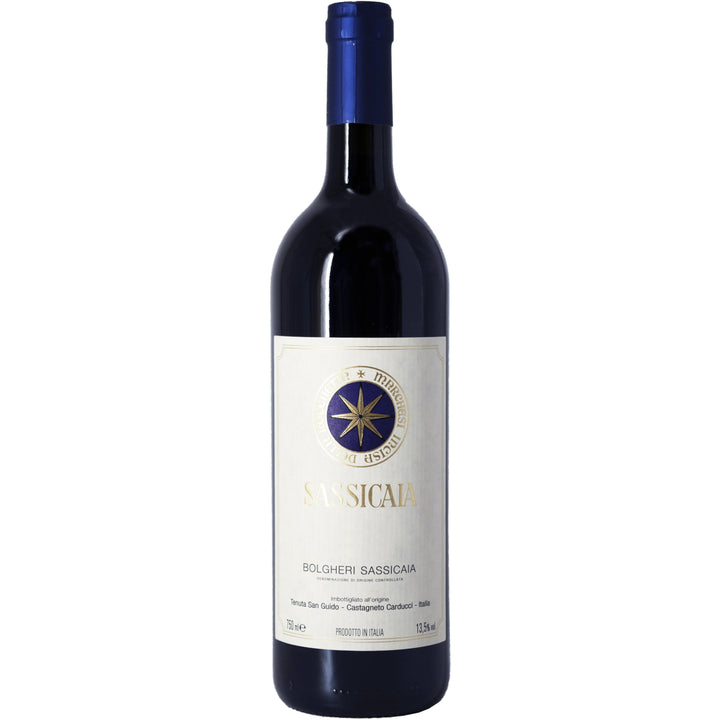 A bottle of Sassicaia, the renowned Bolgheri Super Tuscan wine from Tenuta San Guido, featuring its signature blue and gold label.