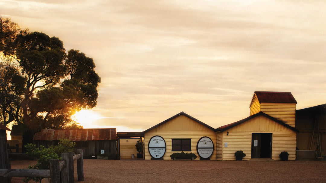 Yellow building with circular signs on a cloudy day