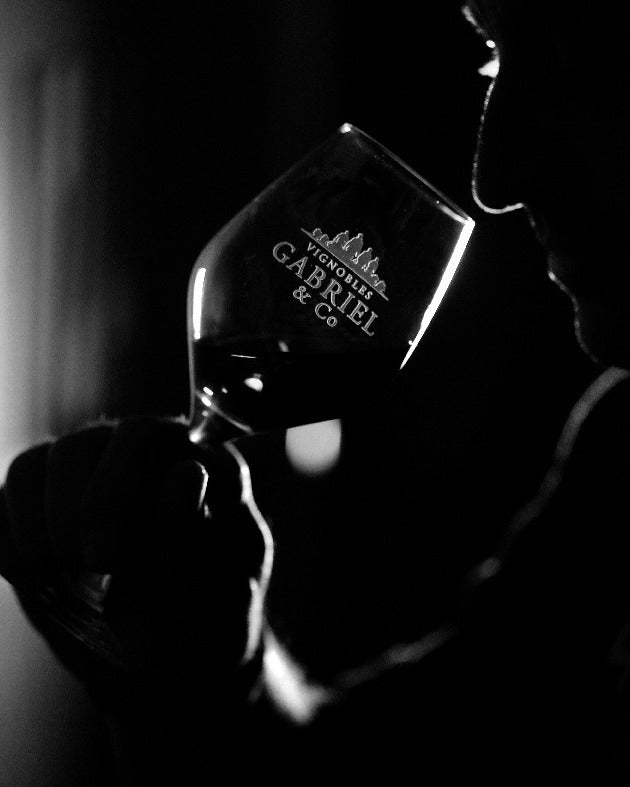 Winemaker tasting red wine at Vignobles Gabriel in Bordeaux